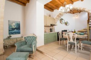 a kitchen and living room with a table and chairs at Elenis Dream House in Plaka Chania in Plaka +27 photos