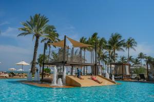 a slide in the middle of a pool at a resort at Dusit Thani Hua Hin in Cha Am