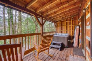 a rocking chair on a porch of a cabin at Leather And Lace #1615 in Gatlinburg