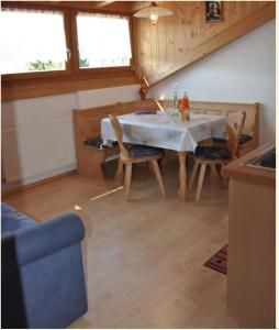 a kitchen with a table and chairs in a room at Rosenheim Appartement 2 in Maranza +14 photos