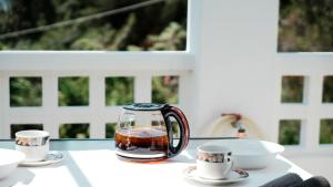 a tea kettle and two cups on a table at Asteria House in Animborió +49 photos