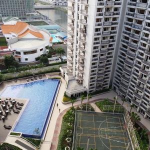 an overhead view of a pool in a city with tall buildings at Solemare Parksuites Condominium - Condo R Us in Manila