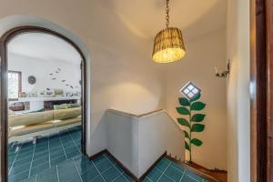 a hallway with a mirror and a pendant light at Stintino villa with view over Asinara Island in Stintino
