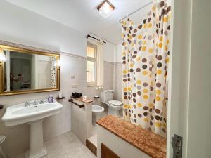 a bathroom with a sink and a toilet and a shower at Villa Artemis in Graniti +44 photos