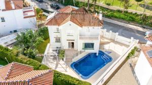 an aerial view of a house with a swimming pool at Exclusive Villa, private pool, BBQ and beach access REMS in Torremolinos