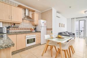 a kitchen and dining room with a table and chairs at Apartamento B y G Nerja in Nerja
