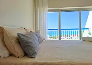 a bedroom with a bed with a view of the ocean at Praia da Rocha in Portimão