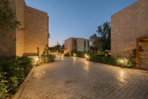 a cobblestone street in front of a building with lights at Mimosa Mansions in Bodrum City