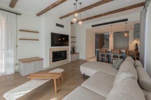 a living room with a couch and a fireplace at Mimosa Mansions in Bodrum City