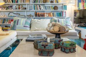 a living room with a couch and a table at Stintino villa with view over Asinara Island in Stintino