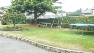 a park with a swing and a table and a bench at 289 Midway Motel in Oamaru