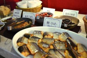 a table with a bowl of food on a table with signs at Citadines Central Shinjuku Tokyo in Tokyo