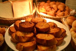 a plate of pastries on a table with bread at Citadines Central Shinjuku Tokyo in Tokyo