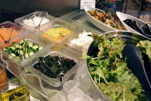 a table topped with plastic containers filled with different types of food at Citadines Central Shinjuku Tokyo in Tokyo