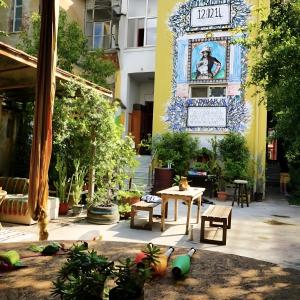 a courtyard with a table and chairs in a building at Tirana Backpacker Hostel in Tirana