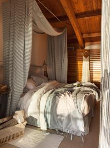 a bedroom with a large bed with a wooden ceiling at Boavista Apartment in Praia da Vitória