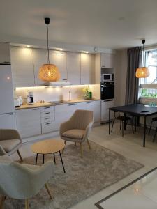 a kitchen with a table and chairs and a dining room at Active teerenpeli in Vaasa