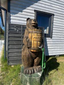 a statue of a bear standing in front of a house at Domki Pod Świerkami in Jezierzany