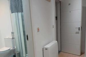 a bathroom with a glass shower and a toilet at Seaview Loft 20 Portrush in Portrush