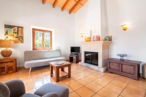 a living room with a couch and a fireplace at Finca can Mandai in Son Carrió