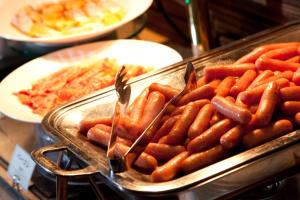 a tray of sausages and other food on a table at Citadines Central Shinjuku Tokyo in Tokyo