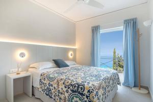 Un dormitorio con una cama con vista al mar. en Myrto Homes Lefkada Agios Nikitas Greece, en Agios Nikitas 50 fotos más