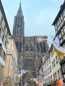 a large cathedral in a city with christmas decorations at Le Coeur Champêtre in Oberhoffen-sur-Moder