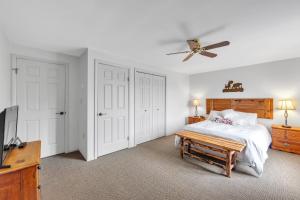 a bedroom with a bed and a ceiling fan at Moxham 58H - Adirondack Retreat Mountain Views in North Creek