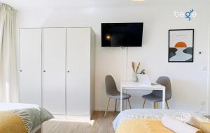 a bedroom with a bed and a desk with a laptop at BEGE APARTMENTS BizConnect in Wuppertal
