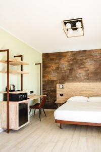 a bedroom with a bed and a desk at Tirreno CODE ROOMS in Tarquinia