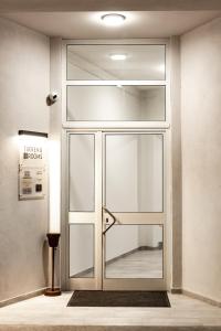 a glass door in a building with a sign on it at CODE ROOMS by Hotel Villa Tirreno in Tarquinia