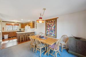 a kitchen and dining room with a wooden table and chairs at Quick Silver 9D - Comfy Townhome for All Seasons in North Creek