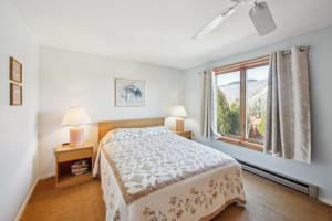 a bedroom with a bed and a window at Quick Silver 9D - Comfy Townhome for All Seasons in North Creek
