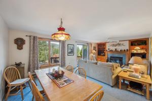 a living room with a table and a couch at Quick Silver 9D - Comfy Townhome for All Seasons in North Creek
