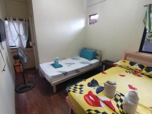 a room with two beds in a room at Ken's Inn in Coron