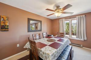 a dining room with a table and a ceiling fan at Hawkeye 21E - Spacious Townhome for Families in North Creek