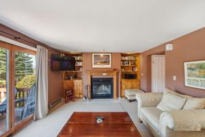 a living room with a couch and a fireplace at Hawkeye 21E - Spacious Townhome for Families in North Creek