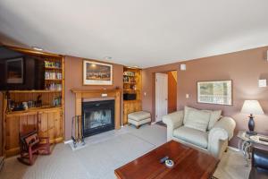 a living room with a couch and a fireplace at Hawkeye 21E - Spacious Townhome for Families in North Creek