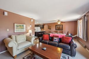 a living room with a couch and a table at Hawkeye 21E - Spacious Townhome for Families in North Creek +22 photos