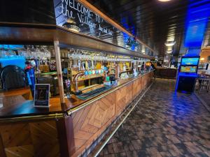 a bar in a pub with a lot of alcohol at Villager Hotel, Ingoldmells in Ingoldmells