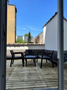 a patio with two chairs and a table on a balcony at MIDI cozy apartment in Brussels