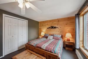 a bedroom with a bed with a wooden wall at Cloud 50G - The Ultimate Adirondack Experience in North Creek