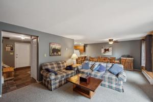a living room with a couch and a table at Cloud 50G - The Ultimate Adirondack Experience in North Creek
