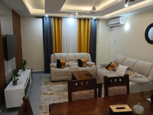 a living room with two couches and a tv at Nyali best pavil in Mombasa