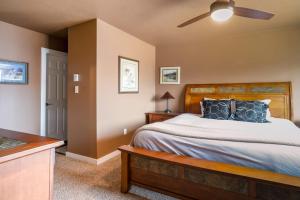 a bedroom with a bed and a ceiling fan at 3BR Big Sky Getaway with Hot Tub and Mountain Views in Big Sky +19 photos