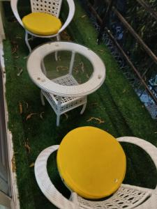 a table and two chairs and a yellow table and chairs at Nyali best pavil in Mombasa