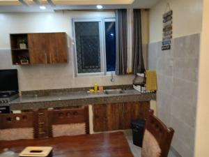 a kitchen with a table and a sink and a window at Nyali best pavil in Mombasa +95 photos