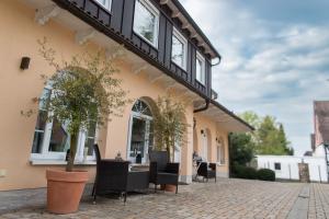 a patio of a house with chairs and a table at Landhaus Chica in Salzgitter