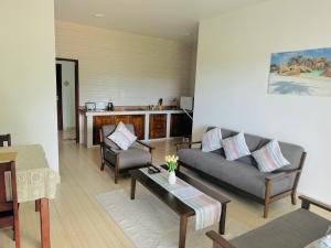 a living room with a couch and a table at Bijoutier Apartments in Grand'Anse Praslin