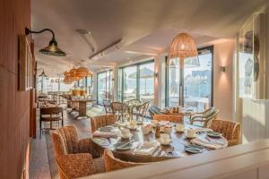a dining room with a table and chairs at Sands Edge in Salcombe